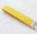 White flowers on yellow with glitter dots Fabric Key Wristlet