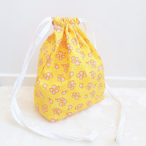 Sunshine yellow with white flowers drawstring bag